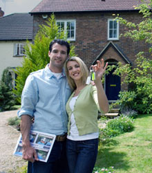 A happy couple who have just got the keys to their new house